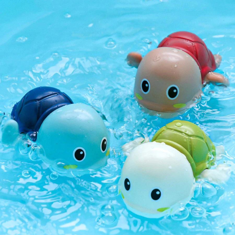 Wind-up swimming turtle bath toys floating in tub