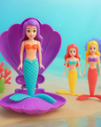 Mermaid toy spiraling up from pink shell underwater