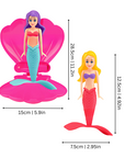 Mermaid toy spiraling up from pink shell underwater – view 2